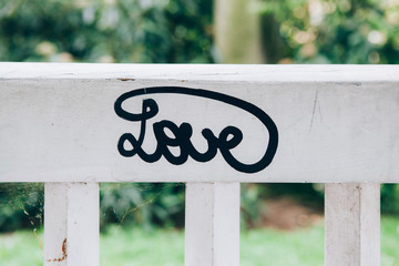 White wooden bench with lettering "love"