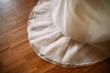 Wedding dress detail wooden floor