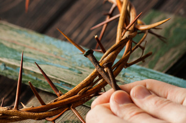 Crown of thorns on wood desk. Christian concept