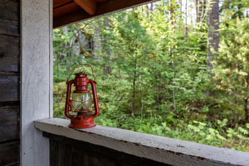 Old red kerosene lamp on the veranda