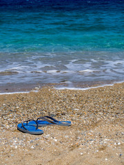 Fototapeta na wymiar Amorgos,Greece-August 1 ,2017.blue flops near the beach