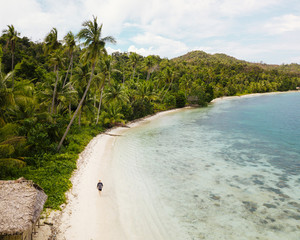 Solo male traveler enjoying an empty beach in Indonesia