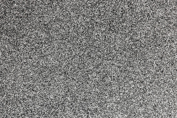 Balck and white monochrome grain made with black paint sprayed onto white paper background.