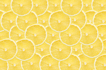 Fresh and vibrant yellow lemon slices pattern texture background.