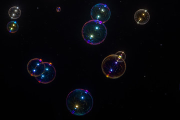 Beautiful colored soap bubbles on black background for texture
