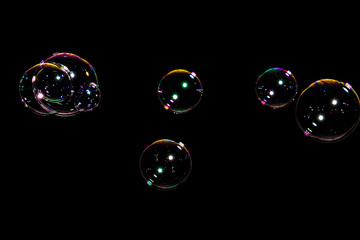 Beautiful colored soap bubbles on black background for texture