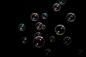 Beautiful colored soap bubbles on black background for texture
