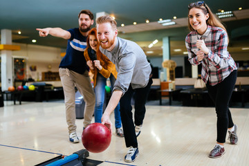 Fototapeta na wymiar Friends having fun while bowling