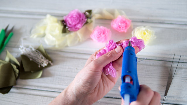 Woman doing kanzashi of satin ribbons. Women's handicrafts. Kanzashi ribbons.