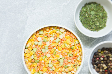 Set of raw ingredients for Italian cooking on stone table background. Black papper, beans, green dry species. Set of healthy food products. Closeup