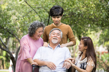 Portrait of Asian Family Relaxing In Park Together. People lifestyle concept.