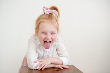 A girl with tooth decay shows her tongue