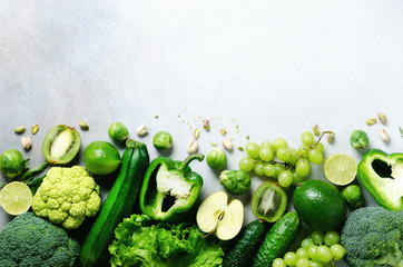 Organic green vegetables and fruits on grey background. Copy space, flat lay, top view. Green...