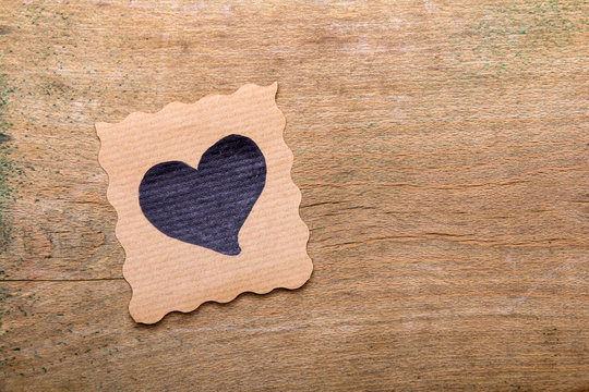 Card with heart drawing  on wooden background. Copy space. Valentine's day background.