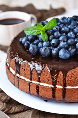 Homemade chocolate cake with cream and blueberries on a white background. Happy Birthday.