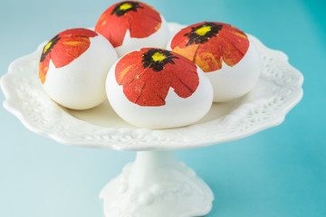 Easter decorated eggs on white plate.