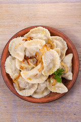 Dumplings, filled with beef meat and served with fried onion. Varenyky, vareniki, pierogi, pyrohy. Dumplings with filling
