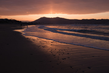 mountain Jaizkibel backlit on atlantic coastline in beautiful red golden sunset, hendaye, france