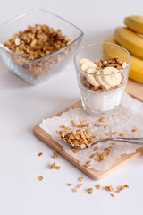 Ingredients for homemade oatmeal granola in glass jar. Oat flakes, honey, raisins and nuts. Healthy breakfast concept with copy