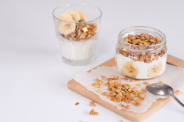 Ingredients for homemade oatmeal granola in glass jar. Oat flakes, honey, raisins and nuts. Healthy...