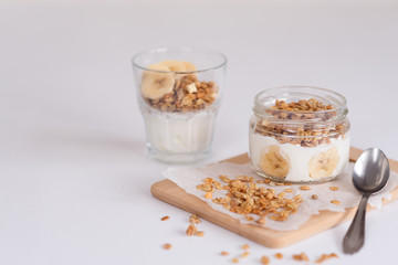 Ingredients for homemade oatmeal granola in glass jar. Oat flakes, honey, raisins and nuts. Healthy breakfast concept with copy