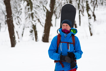 Happy snowboarder stands in the winter forest © sanechka