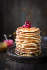 Pancakes with honey, jam and berries