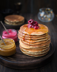Pancakes with honey, jam and berries