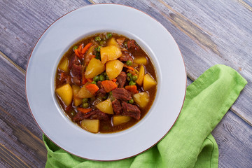 Beef meat stewed with potatoes, carrots, peas and spices. Beef stew, popular dish in Ireland