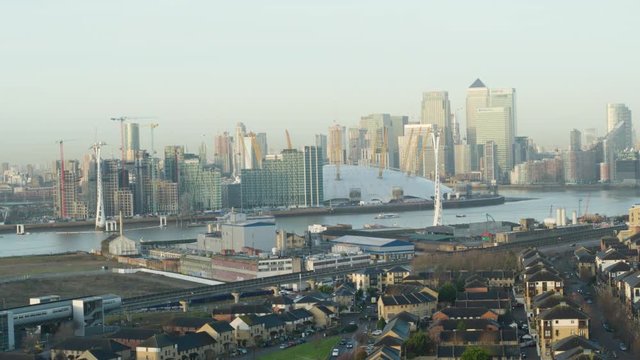 Crane establishing shot of suburbs, River Thames and London cityscape