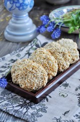 Homemade oat biscuits, cookies with sesame seeds, decorated with spring flowers