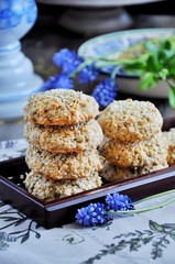 Homemade oat biscuits, cookies with sesame seeds, decorated with spring flowers