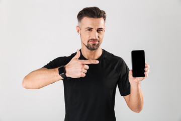 Portrait of a smiling mature sportsman in wireless earphones