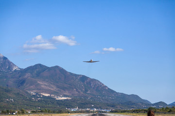 Fototapeta na wymiar Take off the aircraft from the airfield Tivat flying over me. Montenegro. 
