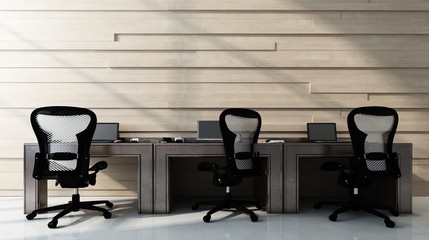 Three chairs standing at workstation desks