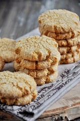 Stacks of homemade honey biscuits with cracks added with coconut