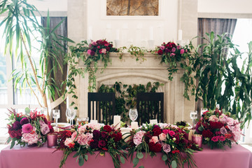 Fireplace decorated with flowers of asters and dahlias and candles