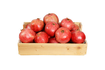 Pomegranate in wooden box on white background