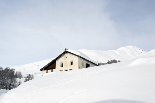 A village house in the snow covered hill in the alps switzerland in winter