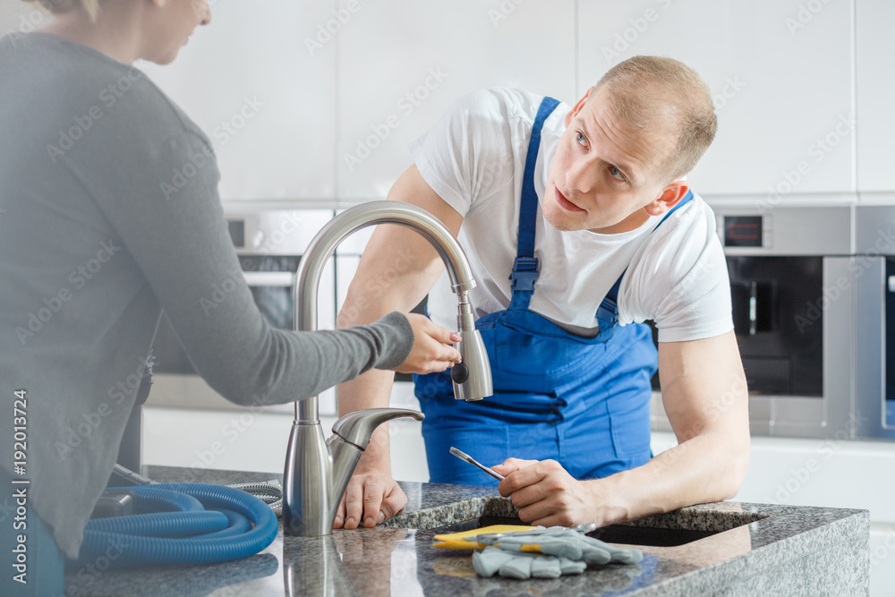 Wall mural woman talking to plumber