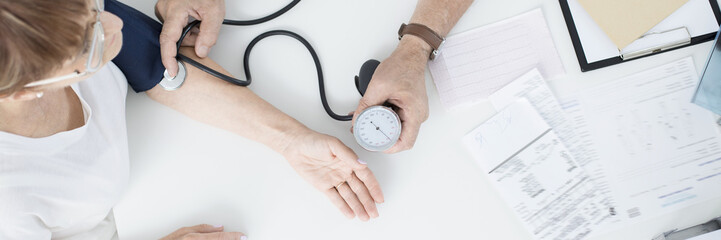 Doctor measuring patient's pressure