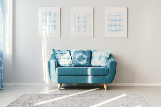 Turquoise living room with posters