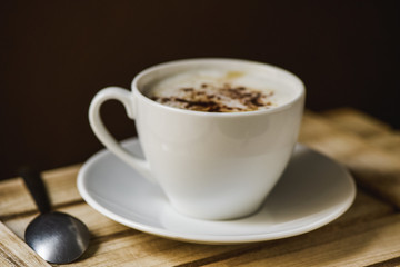 cup of cappuccino on a wooden tray