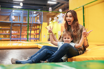 Cheerful young mother playing with her little son © Drobot Dean