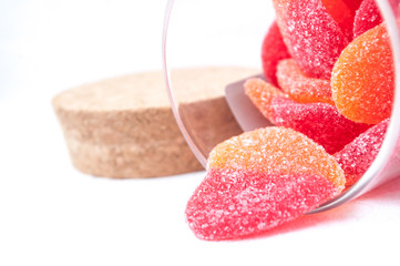 Fototapeta na wymiar bonbons en forme de coeur et bocal en verre sur fond blanc