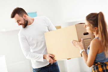 Happy adult couple moving out or in to new home