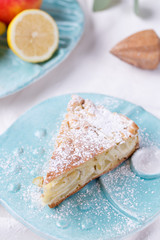 apple pie on a blue plate. lemon with apples