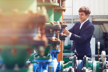 Cheerful engineer trainee checking the pipeline