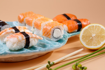 rolls and sushi on a plate in the form of fish