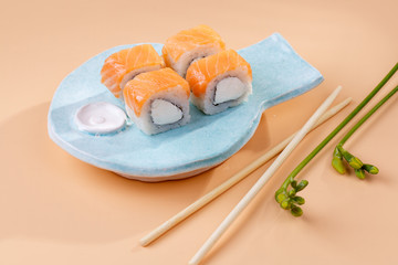 rolls and sushi on a plate in the form of fish